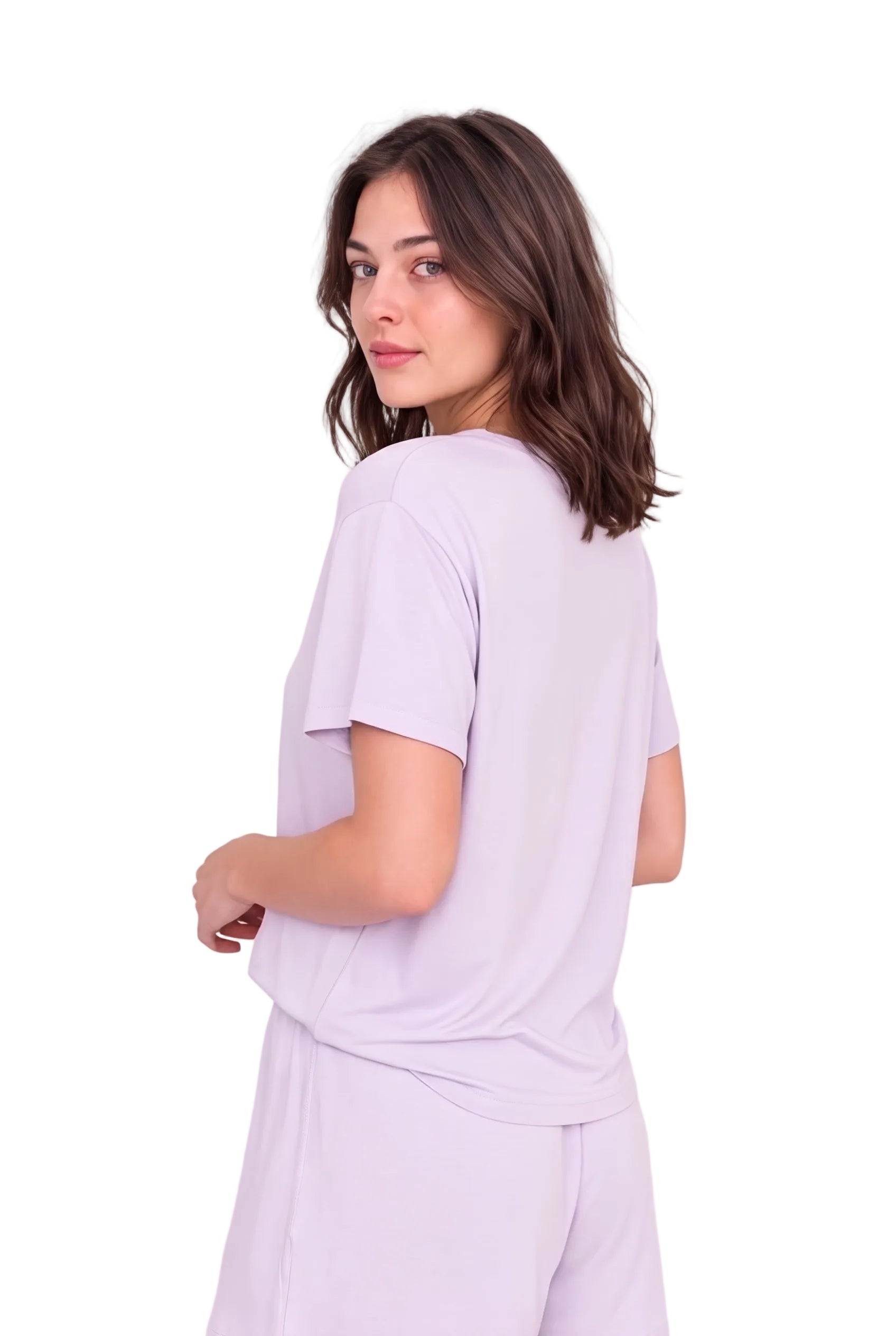 A woman with shoulder-length brown hair is shown from the back wearing a light lavender short-sleeve t-shirt and matching light lavender pants against a plain white studio background.
