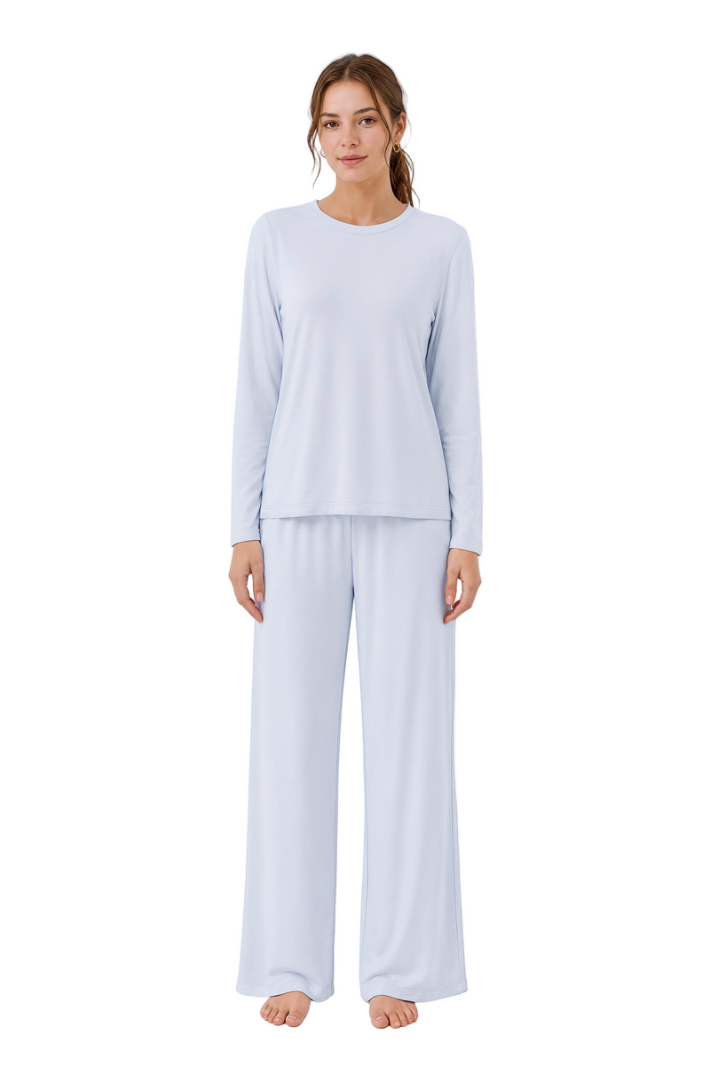 Woman wearing light blue pajamas on a white background