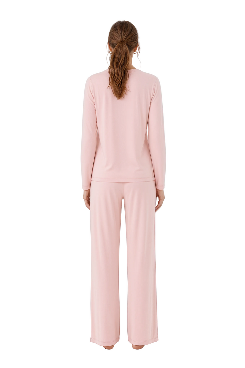 Person wearing a pink outfit on a white background