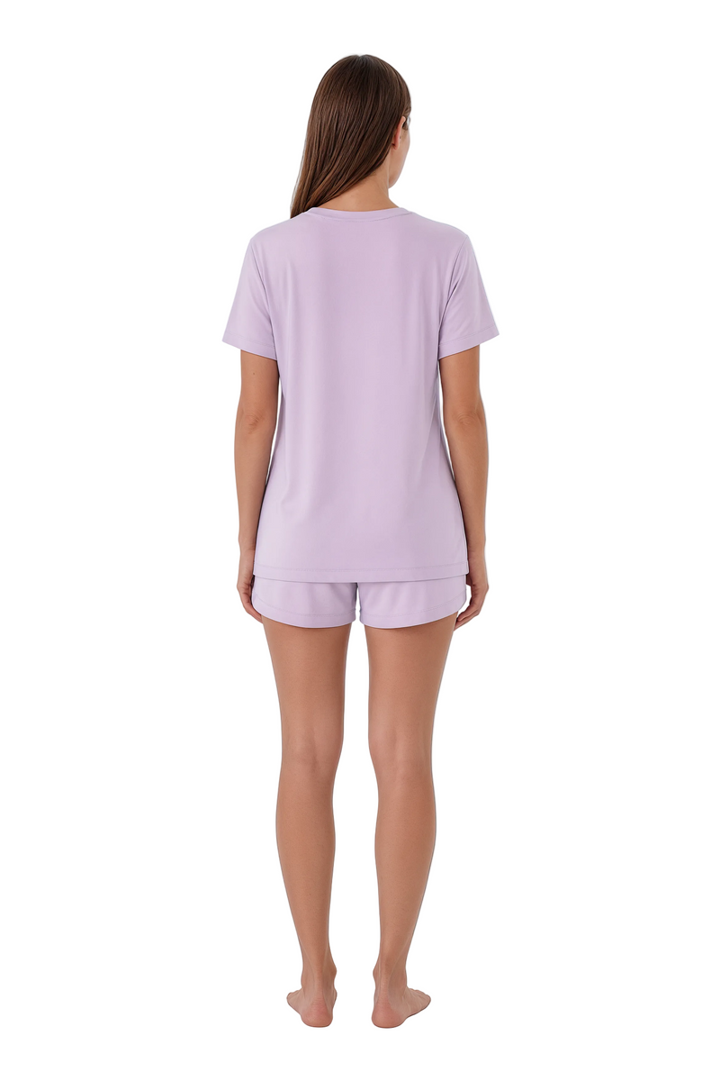 Woman wearing a light purple pajama set on a white background