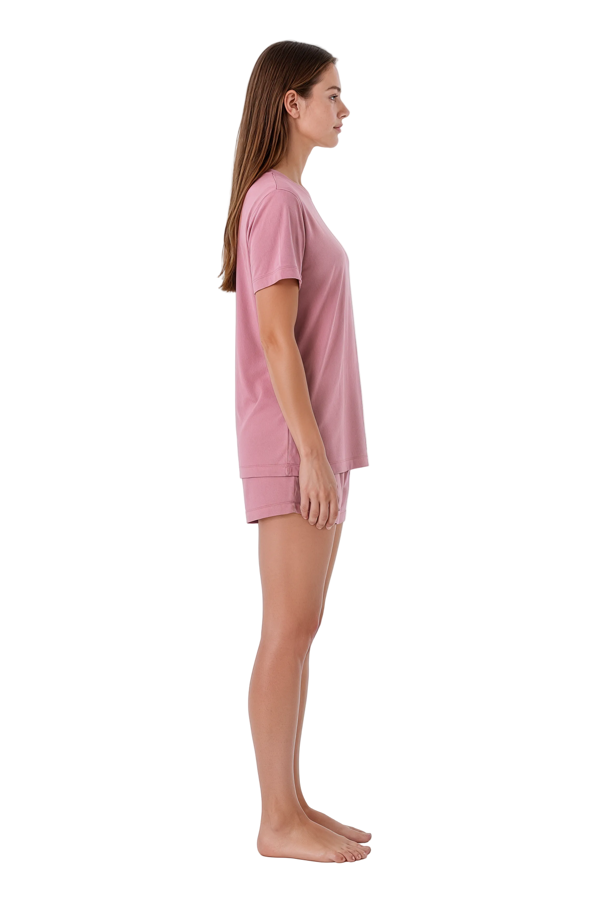 A woman in a side profile wearing a dusty pink short-sleeve t-shirt and matching shorts against a plain white background.