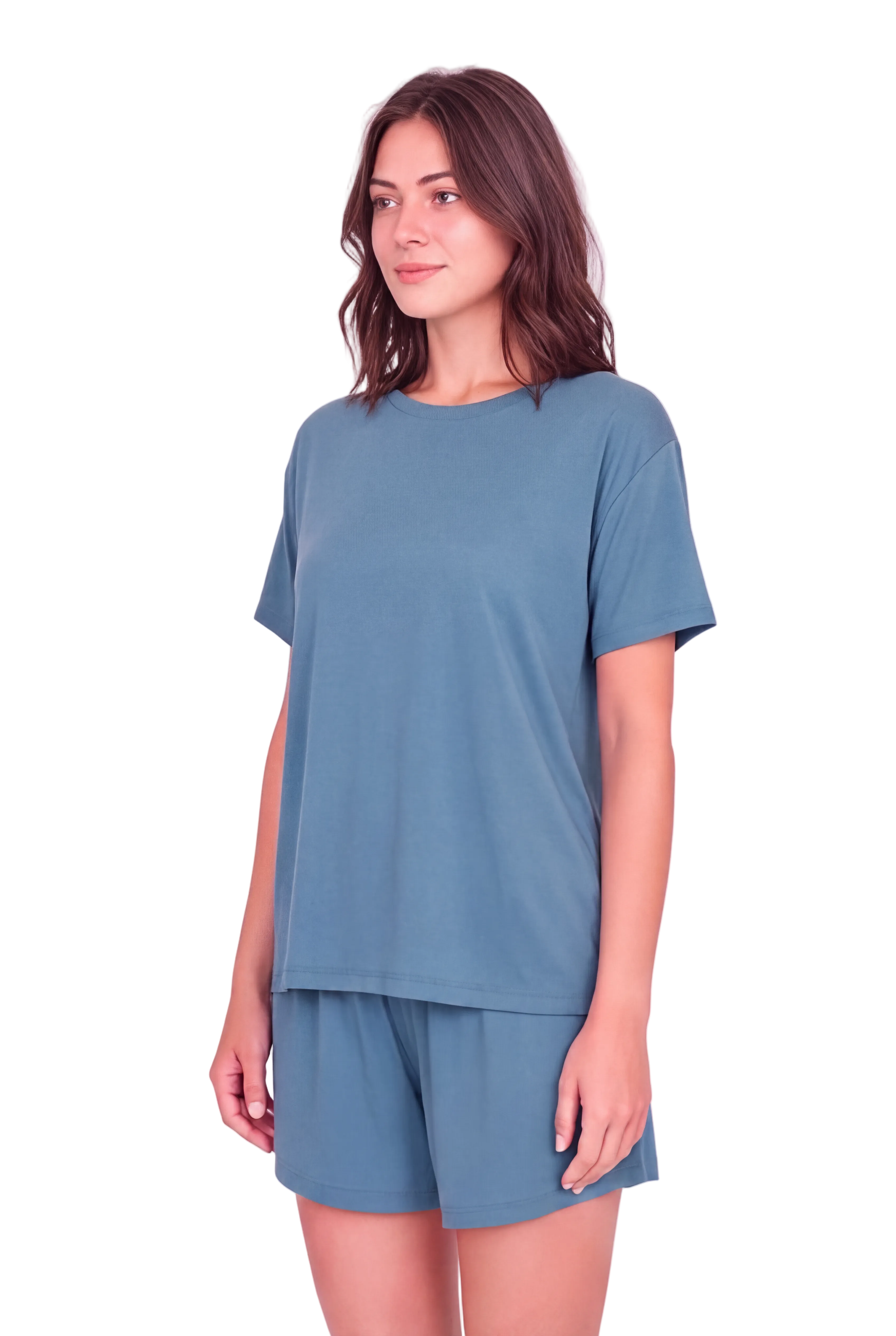 A woman modeling a matching dusty blue lounge set consisting of a short-sleeve crewneck t-shirt and matching shorts, set against a solid pale pink background.