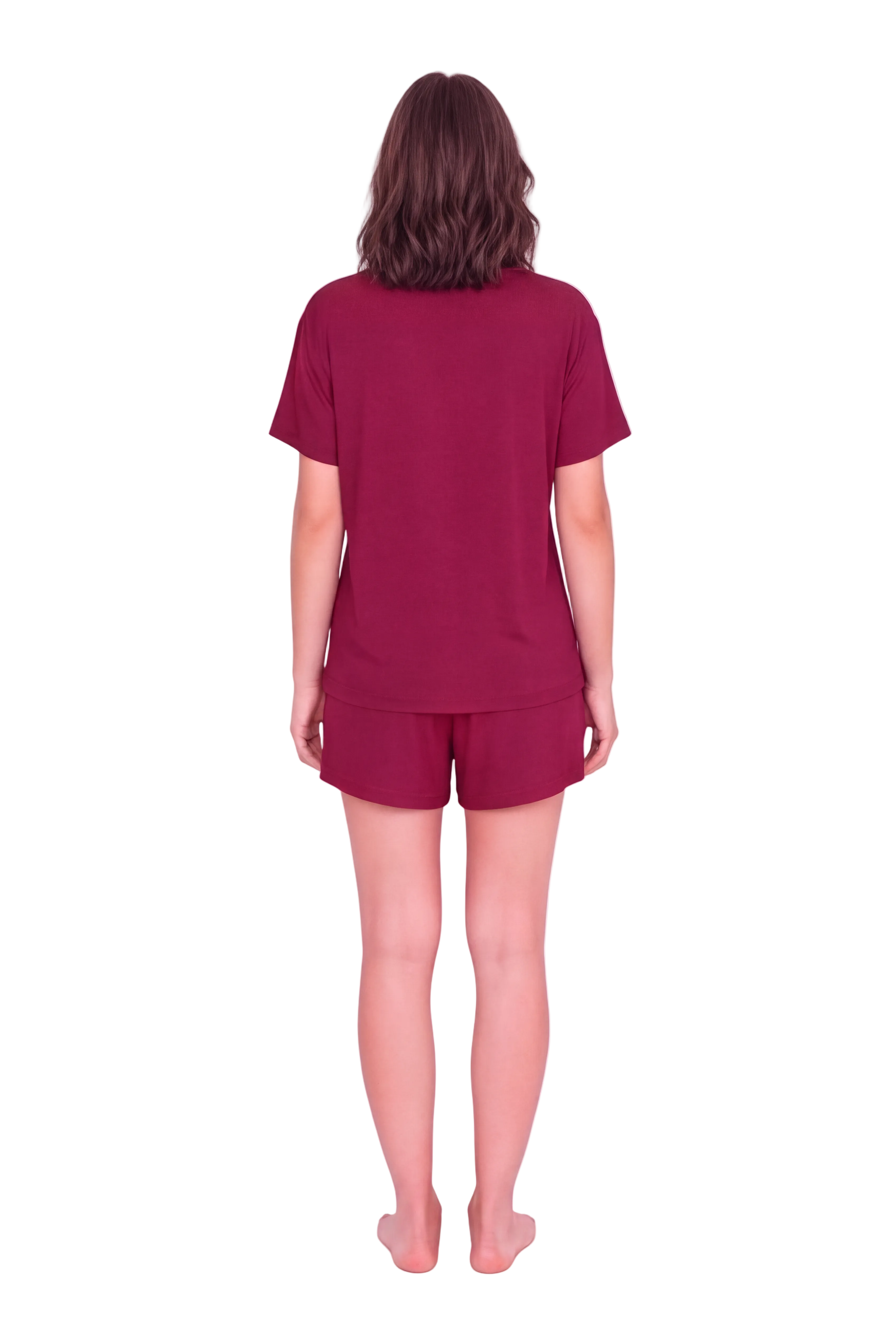 A woman viewed from behind wearing a matching burgundy short-sleeve t-shirt and shorts set against a light pink studio background.
